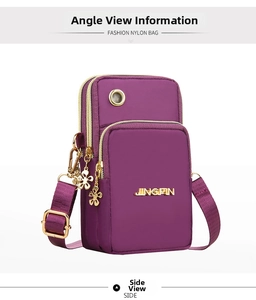 Macro view of purple nylon crossbody phone bag featuring a gold logo and floral zipper charms