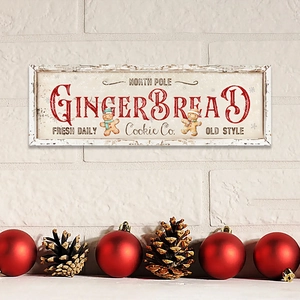 Detail of North Pole Gingerbread Cookie Co. wooden sign with festive holiday motifs