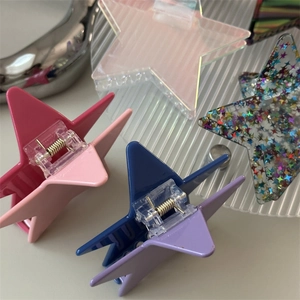 Set of five star-shaped hair claws in assorted pastel colors and glitter finishes