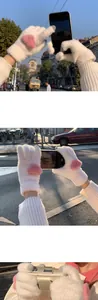 Detail showing white knit thermal gloves with pink heart patch and touch screen fingertips