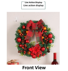 Front view of Christmas wreath with red bow, pine cones and golden ornaments on wall