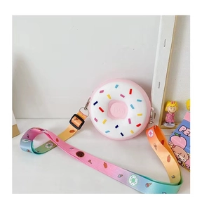 Detail view of pink doughnut silicone purse with rainbow strap and colorful sprinkles