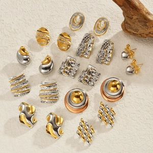 Two-tone abstract geometric stainless steel earrings set on minimalist textured background