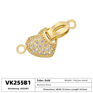 Macro view of gold heart-shaped brass clasp connector with cubic zirconia for jewelry