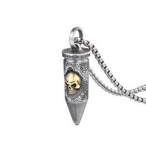 Thai silver bullet pendant necklace featuring a gold skull head and floral carvings