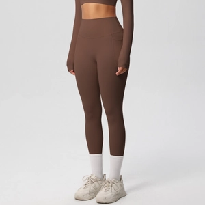 Detail of high waisted brown yoga pants showing the side pocket and soft matte fabric
