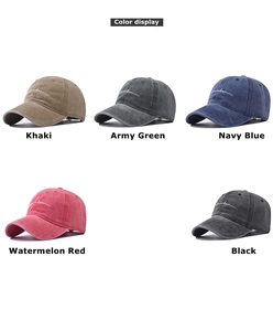 Detail view of washed cotton baseball caps in five vintage colors with white embroidery