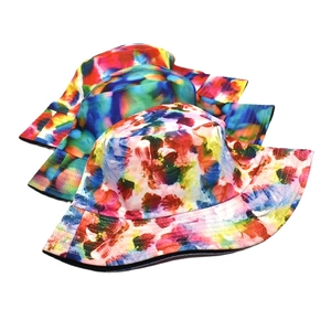 Close-up of colorful tie-dye bucket hats with abstract oil painting graffiti patterns