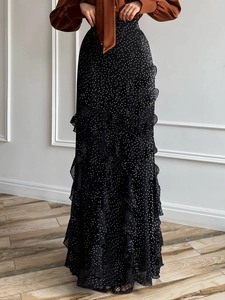 Chic black polka dot maxi skirt with tiered ruffles for elegant vacation styling