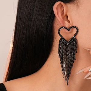 Dark gothic style heart earrings with long black diamond tassels on a female model