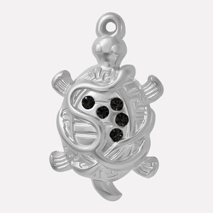 Detailed macro view of silver turtle pendant with sparkling black rhinestones