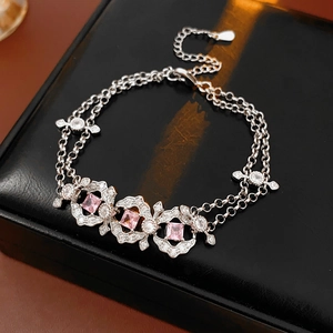 Detail of vintage silver bracelet with pink zircon squares on a black leather box