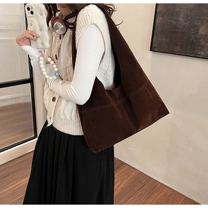 Detail of vintage brown suede tote bag showing large capacity and soft drape texture
