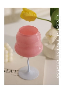 Detail of creative pink and white cream twist wine glass with a unique spiral stem design
