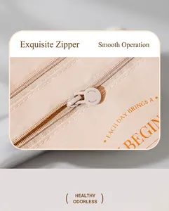 Macro shot of smooth round zipper pull and fabric texture on a beige travel passport bag