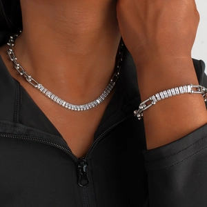 Close-up of a model wearing a horseshoe link chain set with rectangle cubic zirconia