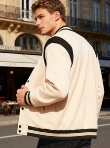 Detail view of American varsity jacket featuring contrast black stripes and ribbed cuffs