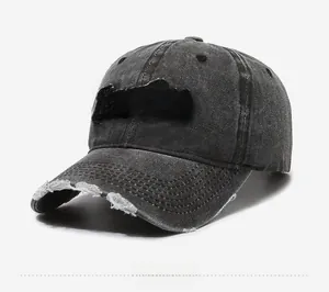 Detailed view of the Purist embroidery and distressed ripped brim on a grey baseball cap