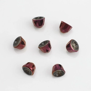 Macro shot of 8mm dark red crystal glass cone beads with iridescent finish and facets