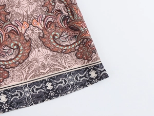 Detail of ethnic paisley print on shirt fabric with turquoise and brown patterns