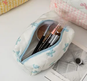 Large capacity quilted white cotton makeup bag with blue bow prints and top zipper