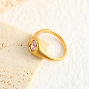 Detailed macro view of a square pink zircon gemstone set on a matte gold stainless steel ring