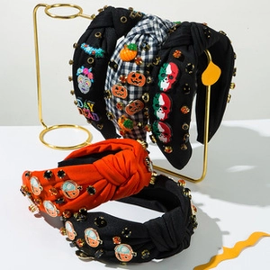 Close-up of Halloween knotted headband with Day of the Dead skulls and sparkling rhinestones