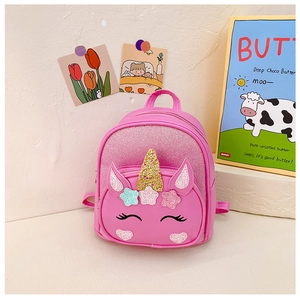 Close-up of pink unicorn backpack with glitter horn and embroidered star details