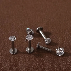 Detailed macro view of five stainless steel labret studs with cubic zirconia in 4-prong setting