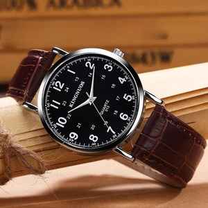 Elegant minimalist quartz watch with silver case and brown leather strap on vintage wood