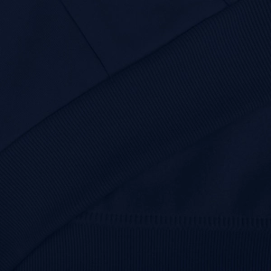 Macro shot of navy blue hooded sweatshirt showing ribbed cuffs and premium knit texture