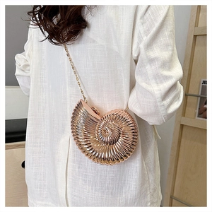 Detailed back view of a snail-shaped gold evening bag with elegant metallic chain strap