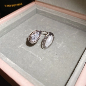 Macro shot of silver adjustable ring with marquise zircon and oval shell inlay in gift box