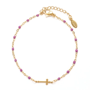 Detail of gold stainless steel bracelet showing purple beads, cross charm and lobster clasp