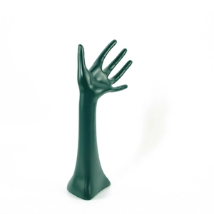 Dark green resin hand-shaped jewelry display stand for rings and bracelets on white background
