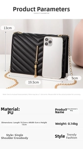 Detailed close-up of a black quilted crossbody bag with gold chain and tassel charm