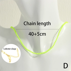 Detail of neon green beaded necklace with adjustable lobster clasp closure and gold finish