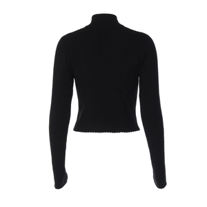 Vue détaillée de la maille côtelée noire et de la coupe courte de ce pull ajusté tendance