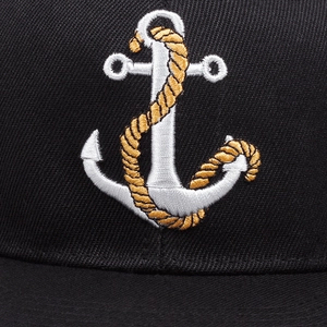 Classic black anchor baseball cap with detailed white and gold embroidery and twill texture