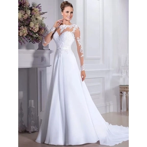 Close-up of white long-sleeved wedding dress with lace embroidery and sheer tulle bodice