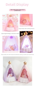 Detailed view of resin angel sleeping in star tent night light with pink and purple tones