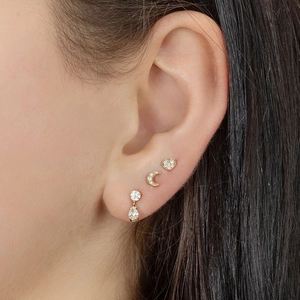 Detail view of gold earrings set featuring micro-pave heart, moon, and teardrop studs