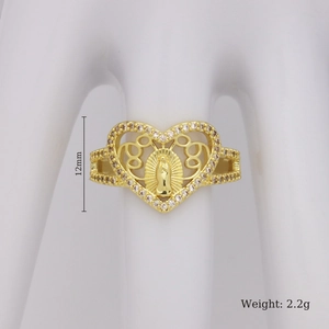 Detailed close-up of a golden hollow heart ring featuring a central icon and zircon stones