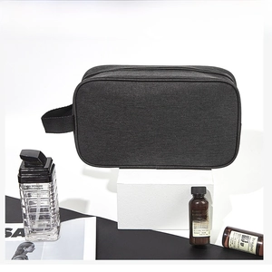 Detail of waterproof black oxford fabric toiletry bag with side handle and zipper closure