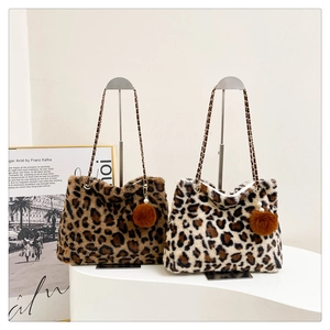 Detailed view of leopard print plush tote bags with chain straps and fur ball charms