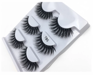 Macro detail of T05 dense black faux mink eyelashes arranged on a white tray