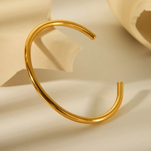 Minimalist 18K gold plated stainless steel open bangle with a polished finish for women