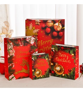 Detail of red Christmas gift bags in four sizes with gold foil Merry Christmas prints