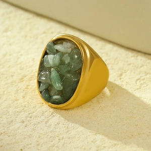 Macro view of gold stainless steel ring with natural green crushed stone inlay detail