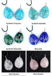 Detail of wire-wrapped tree of life pendants in diverse teardrop-shaped gemstones